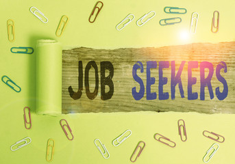 Text sign showing Job Seekers. Business photo text an unemployed demonstrating who is actively looking for employment Paper clip and torn cardboard placed above a wooden classic table backdrop