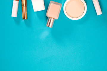 Cosmetics on a blue background. Top view. Text space.