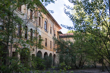 Fototapeta na wymiar An abandoned seminary surrounded by vegetation