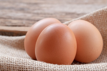 Close up chicken eggs with wooden background