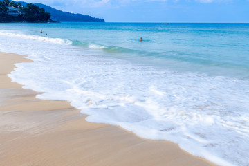 Fototapeta na wymiar the sea wave splay white foam on the beach