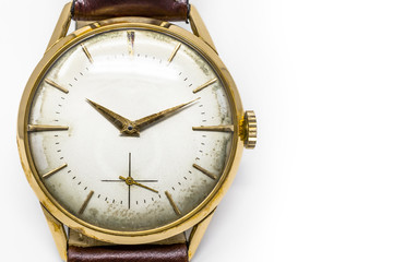 An old gold mechanical wristwatch with manual winding. Antique watch ruined by time, with scratches and mildew stains, rust, oxidation. Leather strap (band). Vintage clock. Spend time.