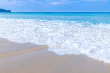 the sea wave splay white foam on the beach