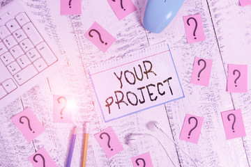Conceptual hand writing showing Your Project. Concept meaning series of tasks that need to be completed to reach an outcome Writing tools and scribbled paper on top of the wooden table