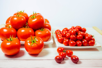 CHERY TOMATOES ON BOARDS ON WHITE BACKGROUND