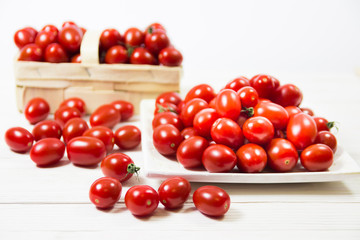 CHERY TOMATOES ON BOARDS ON WHITE BACKGROUND