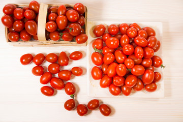 CHERY TOMATOES ON BOARDS ON WHITE BACKGROUND
