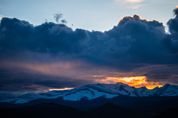 Sunlight leaking through clouds over the Rocky Mountains