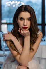Beautiful girl bride in front of the camera, designer dress, sensual look.