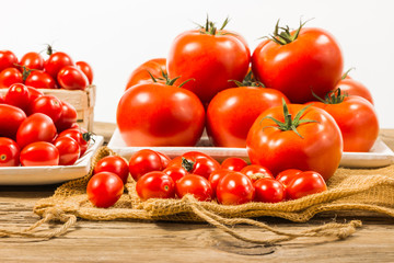 CHERY TOMATOES ON BOARDS WITH SPICES ON WHITE BACKGROUND