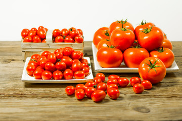 CHERY TOMATOES ON BOARDS WITH SPICES ON WHITE BACKGROUND