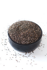 Healthy food concept  super food dried Chia seed in black ceramic cup isolated on white background