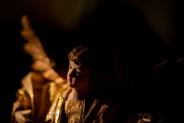 portrait of an angel statue with soft light and a black background 