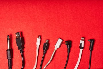 wires with different connectors on a red background