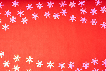 White snowflakes on a red background. New year background concept