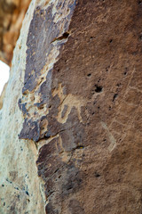 Detail of a part of the petroglyphs incised by the Fremont People in the sandstone rock face at Dinosaur National Monument, Utah