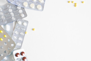 pack of blisters with different pills on a white background with