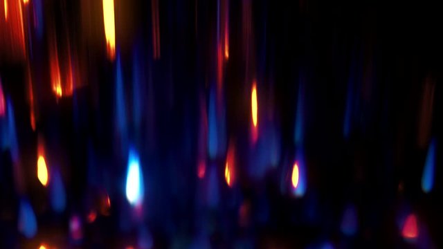 Sparks background. Specks gleam. Blue orange defocused lights on black.