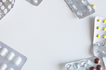packaging blisters with different pills on a white background with copy space