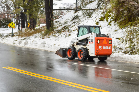 Bobcat snow removal truck on road in winter