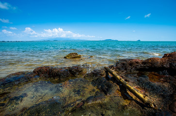 Rocks at sea with blue sky and clouds