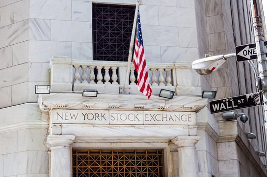 New York, USA - June 18, 2016: New York Stock Exchange with American flags and Wall street sign