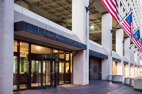 Washington DC, USA - December 29, 2016: FBI, Federal Bureau of Investigation Headquarters, on Pennsylvania avenue sign with American flags