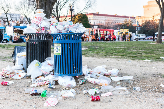 Washington DC, USA - January 28, 2017: Overflowing trash bins in National Mall with people eating by food trucks