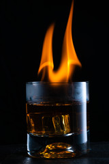 a glass of whiskey and fire