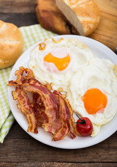 Bacon and eggs for breakfast on the plate