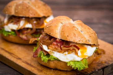 Bacon and egg sandwiches with onions and lettuce