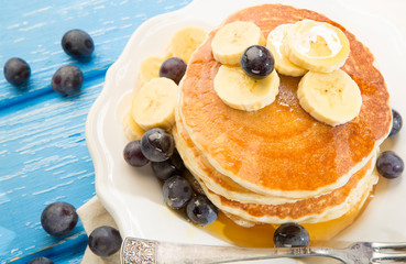 Pancake with banana , blueberries and honey