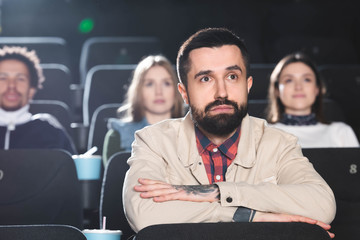 selective focus of handsome man watching movie in cinema