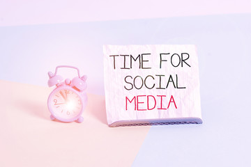 Conceptual hand writing showing Time For Social Media. Concept meaning meeting new friends discussing topics news and movies Alarm clock beside a Paper sheet placed on pastel backdrop
