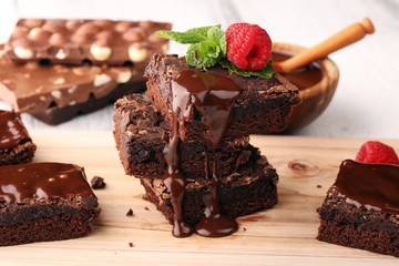 chocolate brownie cake dessert with raspberries and spices on a wooden background.