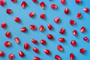 ripe and delicious pomegranate on blue