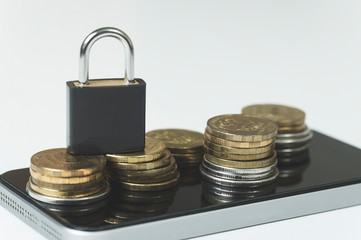 theft of money via smartphone, smartphone coin lock on white background closeup