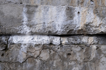 Concrete wall texture with cracks, mold and lichen.