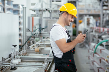 Factory worker in uniform with phone