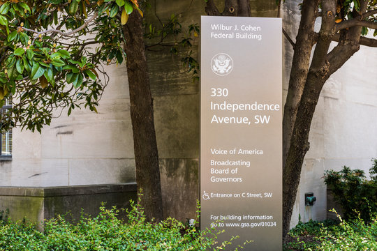 Washington DC, USA - July 3, 2017: Sign for Voice of America and Broadcasting Board of Governers Wilbur J. Cohen building in downtown