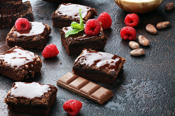 chocolate brownie cake dessert with raspberries and spices on a wooden background.