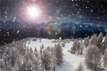 Fototapeta premium Christmas background with snowy fir trees and mountains in heavy blizzard.