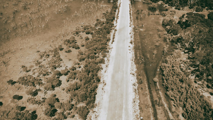 Fototapeta na wymiar Aerial overhead view of road across swamps