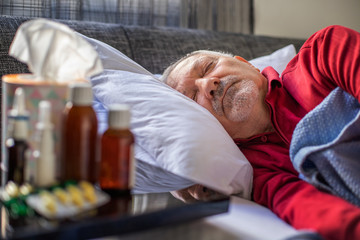 Obraz na płótnie Canvas Elderly man lying on the bed and sleeping