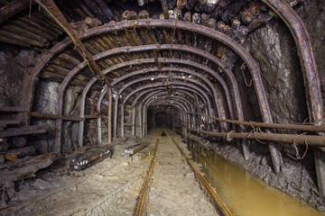 Fototapeta na wymiar Gold iron mine ore shaft tunnel drift with timbering