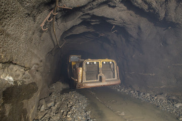 Fototapeta na wymiar Underground mine with load haul dump machine LHD