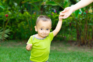 Fototapeta premium Happy Toddler Boy Learning to Walk