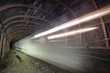 Gold iron mine ore shaft tunnel drift with electric locomotive