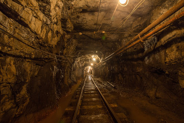 Gold iron mine ore shaft tunnel drift with rails underground