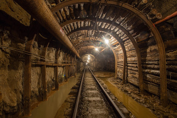 Gold iron mine ore shaft tunnel drift with rails underground